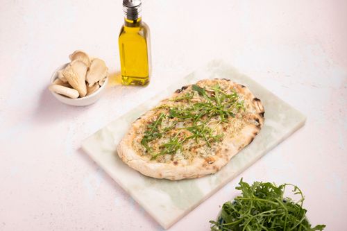 Pinsa Provenzale with vegan cream cheese and oyster mushrooms