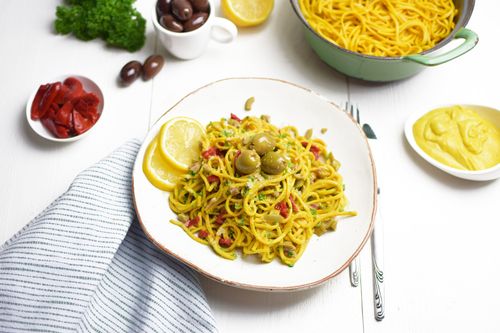 Turmeric pasta with melted vegan cheese and olives