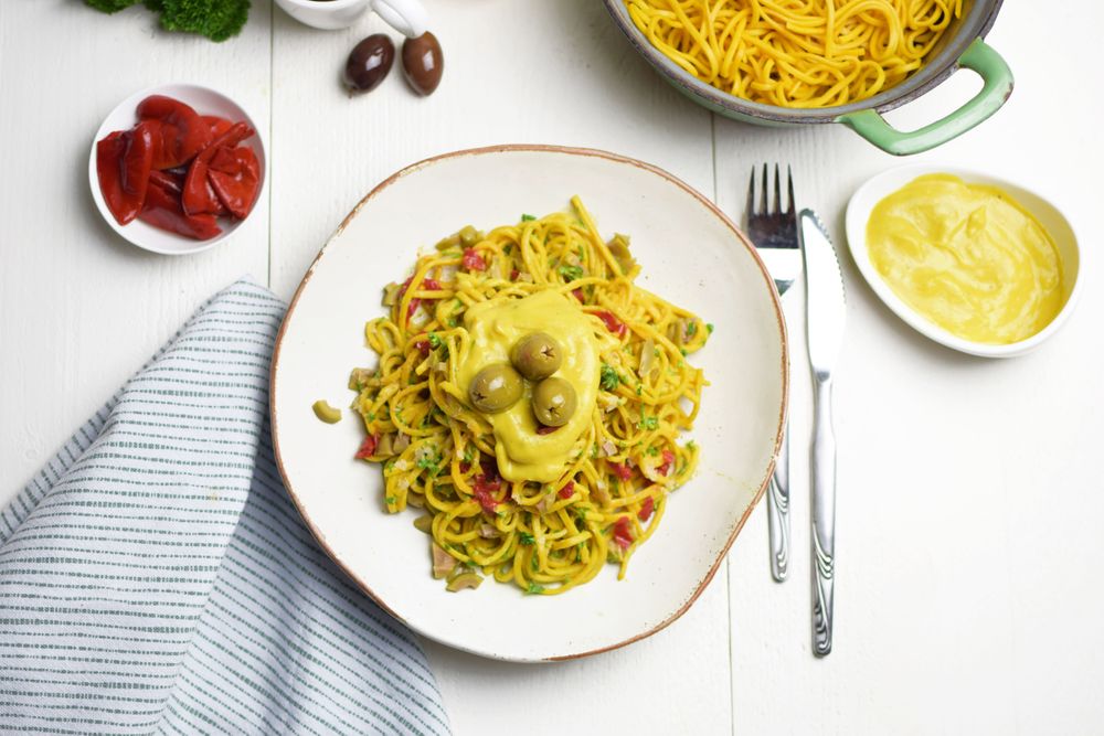 Turmeric pasta with melted vegan cheese and olives | Terrasana Positive  Eating