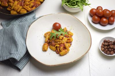 Sencilla pasta de cúrcuma con tomates y rúcula